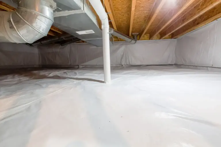 An encapsulated crawl space lined with a white vapor barrier, with ductwork overhead